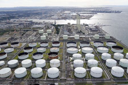 Oil eases 1%, reversing rally, on profit taking, interest rate worries